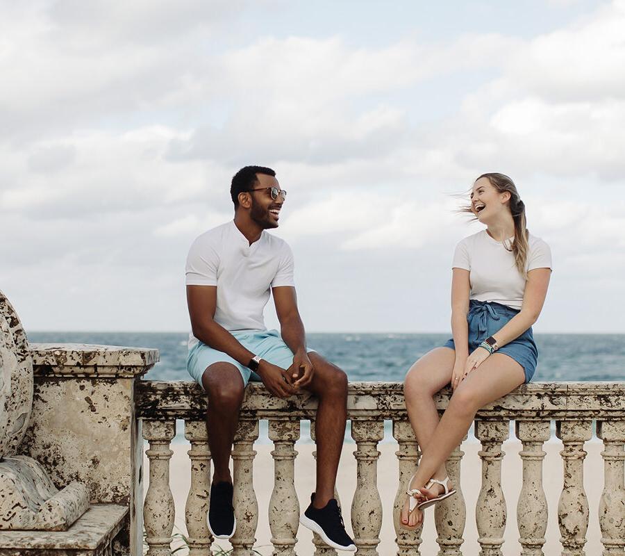 Two PBA students talk by the beach.